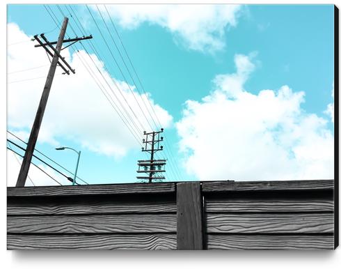 electric pole with wooden wall and blue cloudy sky in the city Canvas Print by Timmy333