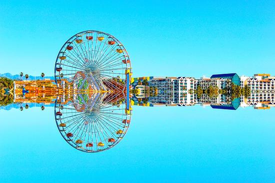 ferris wheel with buildings and blue sky by Timmy333