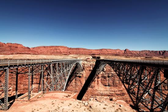 bridge in the desert with blue sky at Utah, USA by Timmy333