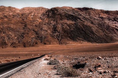 road in the desert with mountain view at Death Valley national park California USA Mural by Timmy333